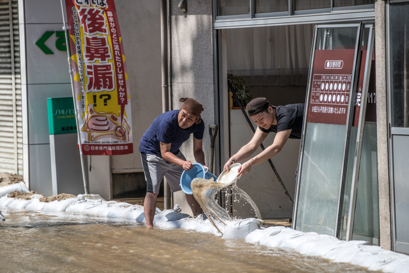 These men are trying to empty water from the property.
